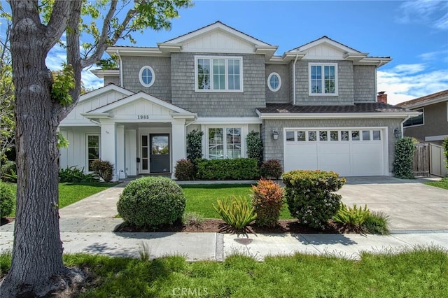 view of front of property featuring a garage and a front lawn