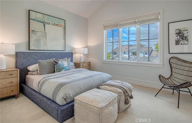 carpeted bedroom with lofted ceiling