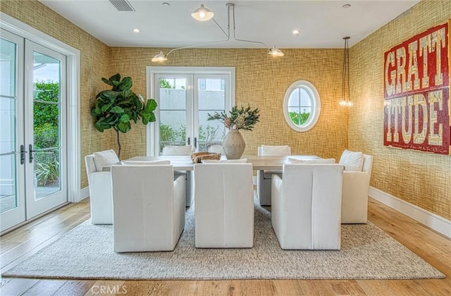 dining area featuring wood-type flooring and french doors