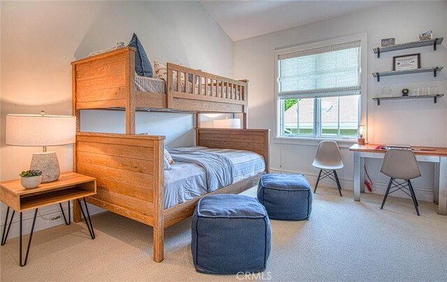 bedroom with vaulted ceiling and carpet flooring