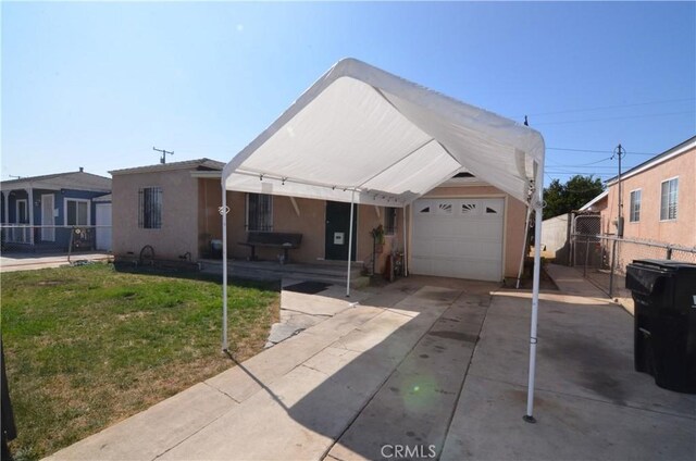 14407 S Corlett Ave, Compton, CA 90220 - view of front of home featuring stucco siding, a garage, and concrete driveway