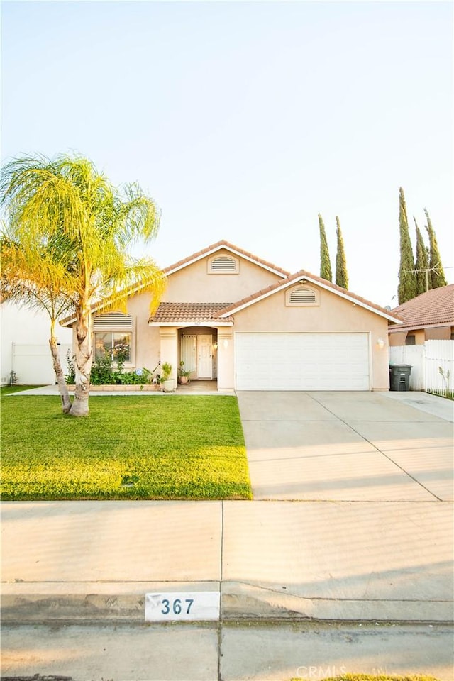 view of front of home with a garage and a front yard