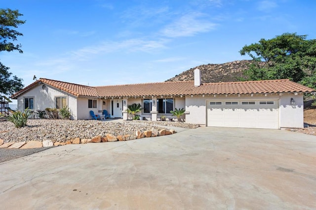 mediterranean / spanish house featuring a garage