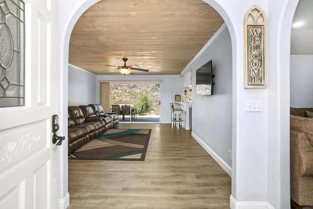 living room with crown molding, wooden ceiling, ceiling fan, and hardwood / wood-style flooring