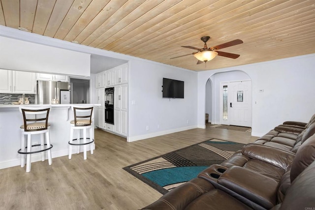 living room featuring light hardwood / wood-style flooring, wooden ceiling, and ceiling fan