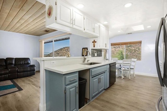 kitchen featuring light wood-type flooring, black dishwasher, sink, and white cabinets