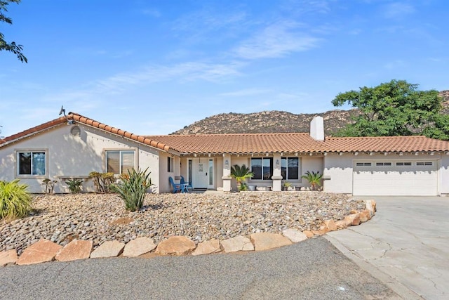 mediterranean / spanish home with a mountain view and a garage