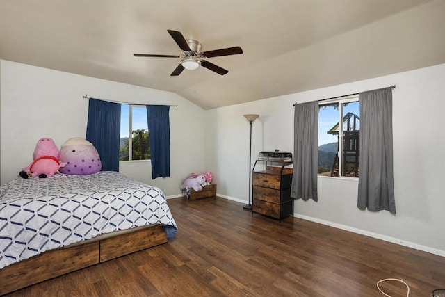 bedroom featuring dark wood-type flooring, ceiling fan, vaulted ceiling, and multiple windows