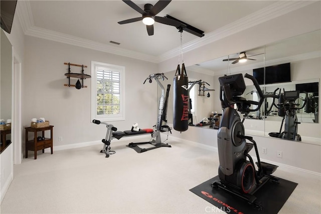 exercise area featuring ceiling fan, light colored carpet, and ornamental molding