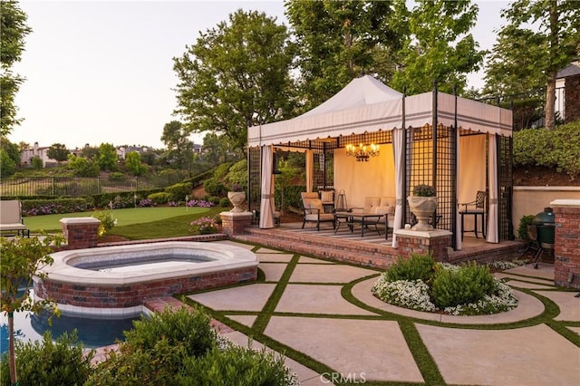 view of patio with an in ground hot tub