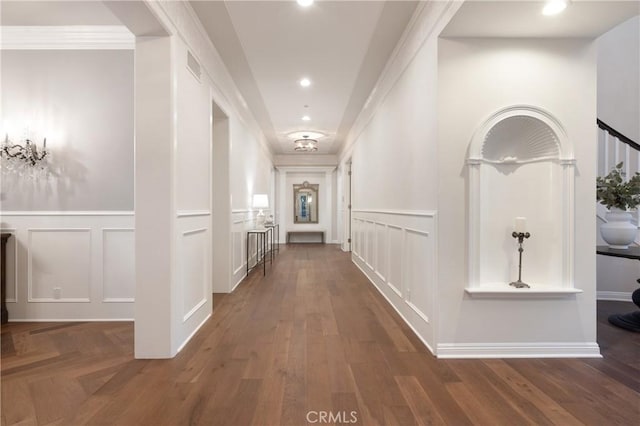 hallway featuring dark hardwood / wood-style flooring and ornamental molding