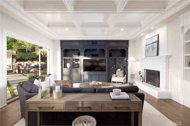 living room featuring beam ceiling, ornamental molding, dark wood-type flooring, and coffered ceiling