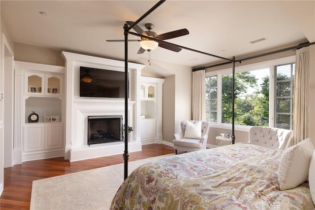 bedroom with dark hardwood / wood-style floors and ceiling fan