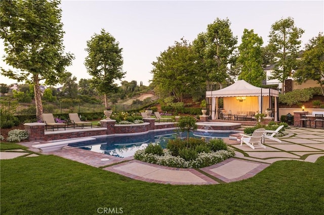 view of swimming pool with a gazebo, a yard, an in ground hot tub, and a patio