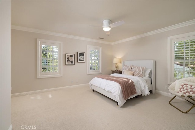 carpeted bedroom with ceiling fan and crown molding