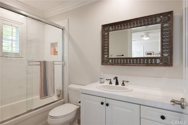 full bathroom with shower / bath combination with glass door, toilet, vanity, and ornamental molding