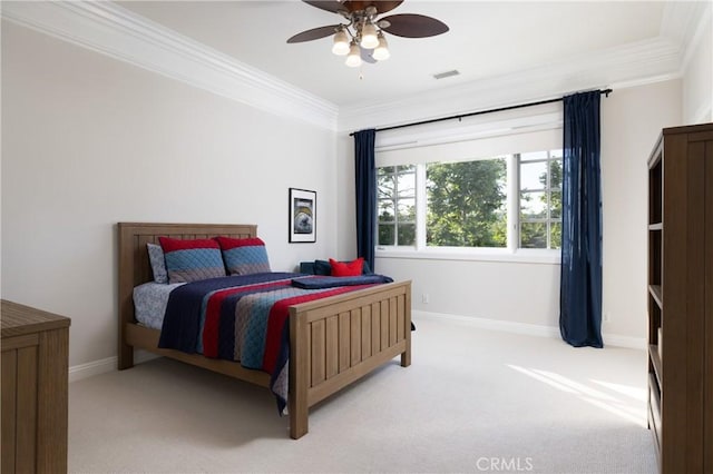 carpeted bedroom with ceiling fan and crown molding