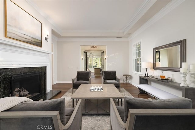 living room with hardwood / wood-style floors, crown molding, and a premium fireplace