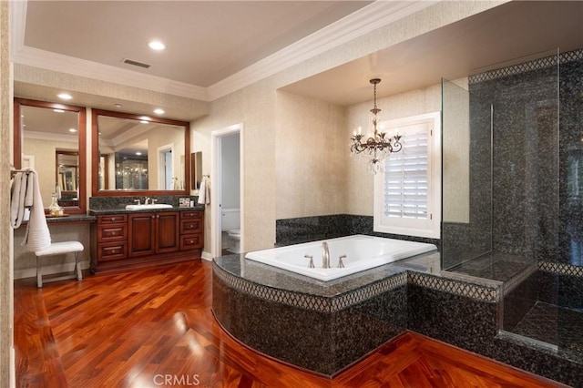 bathroom with a washtub, vanity, crown molding, a notable chandelier, and hardwood / wood-style floors