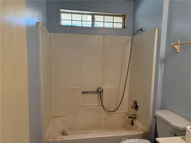 bathroom featuring shower / bathtub combination and toilet