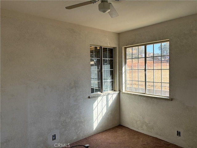 carpeted empty room featuring ceiling fan