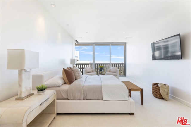 carpeted bedroom featuring access to exterior and floor to ceiling windows