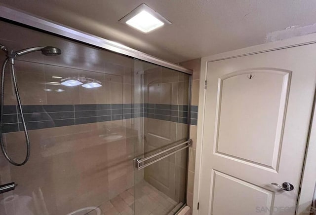 bathroom with a shower with shower door