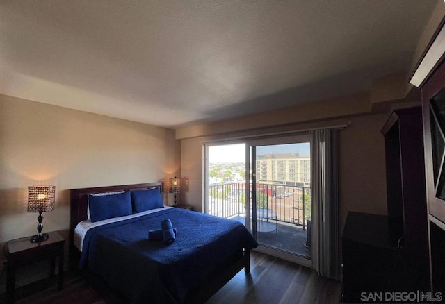 bedroom with dark wood-type flooring and access to exterior