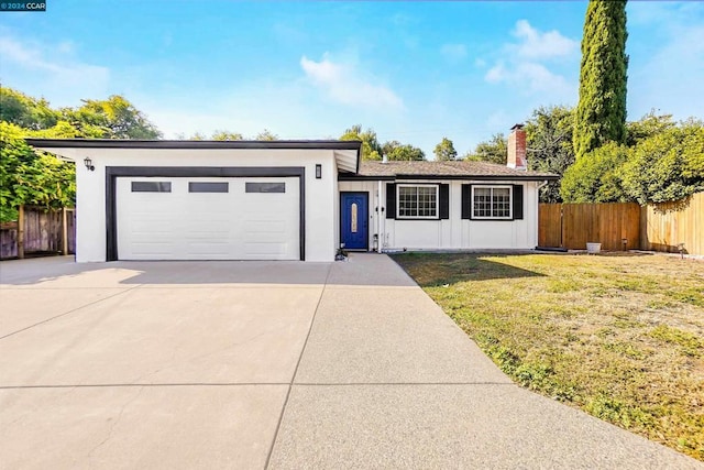 ranch-style house with a front yard and a garage