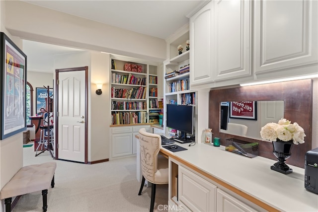 home office with built in desk and light colored carpet