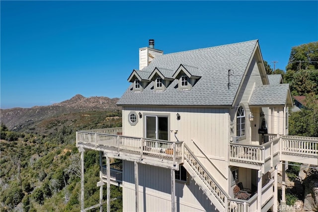 back of house featuring a deck with mountain view