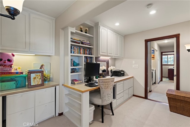 carpeted office space featuring built in desk