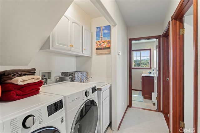 laundry room with light carpet, cabinets, and independent washer and dryer