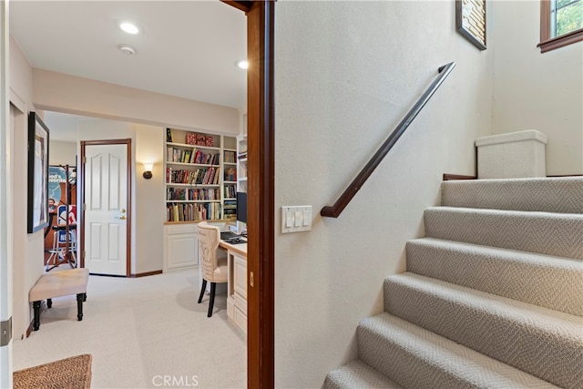 stairs featuring carpet flooring