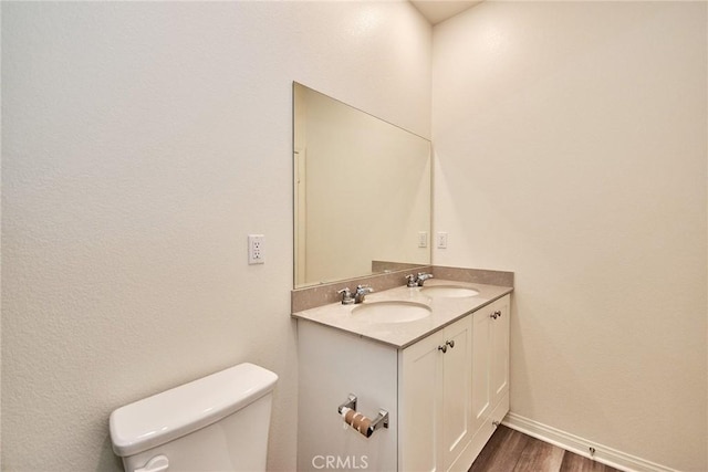 bathroom with vanity, wood-type flooring, and toilet