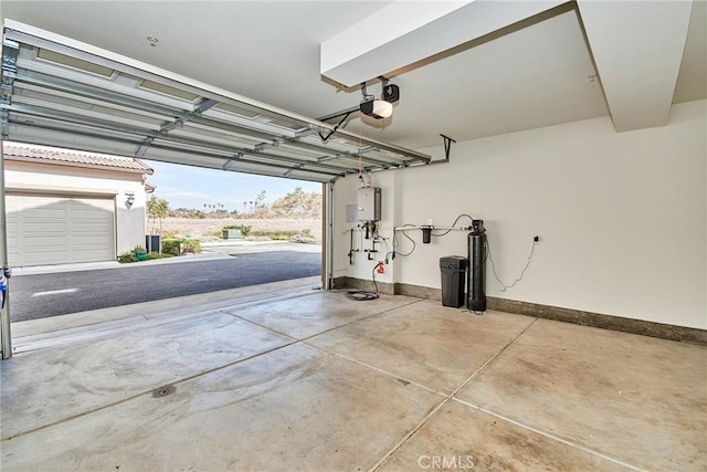 garage featuring a garage door opener and water heater