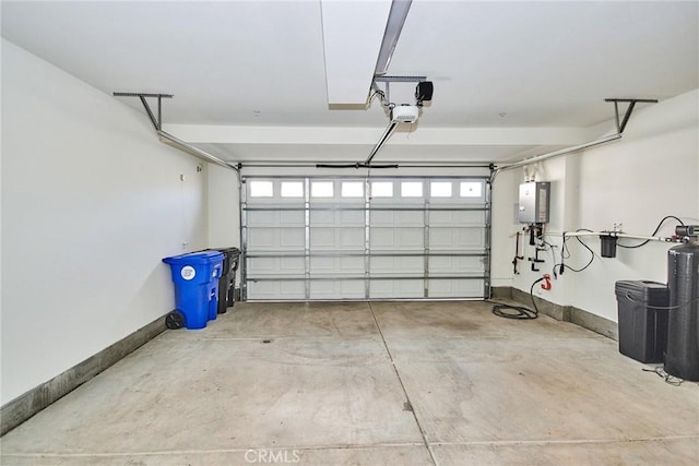 garage with a garage door opener and water heater