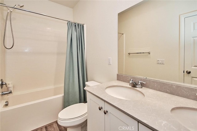 full bathroom with hardwood / wood-style floors, vanity, toilet, and shower / bath combination with curtain