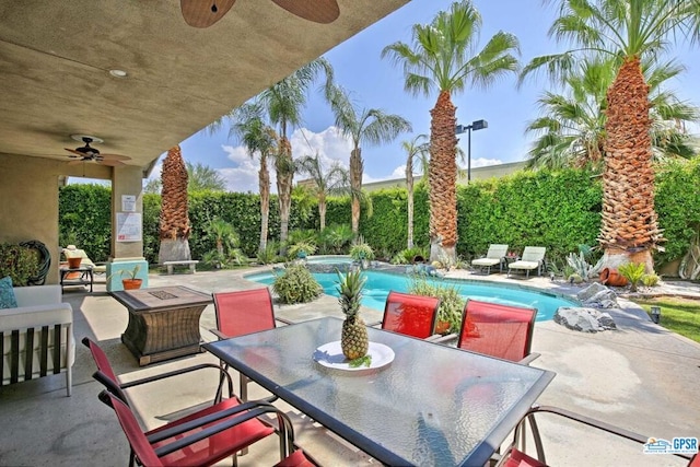 view of patio with ceiling fan and a fenced in pool