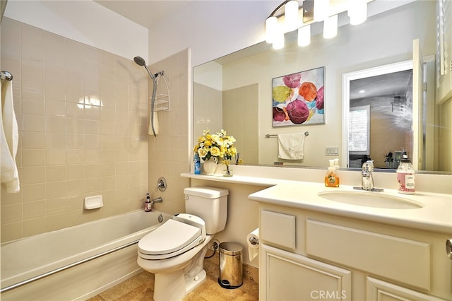 full bathroom featuring tiled shower / bath, vanity, tile patterned flooring, and toilet