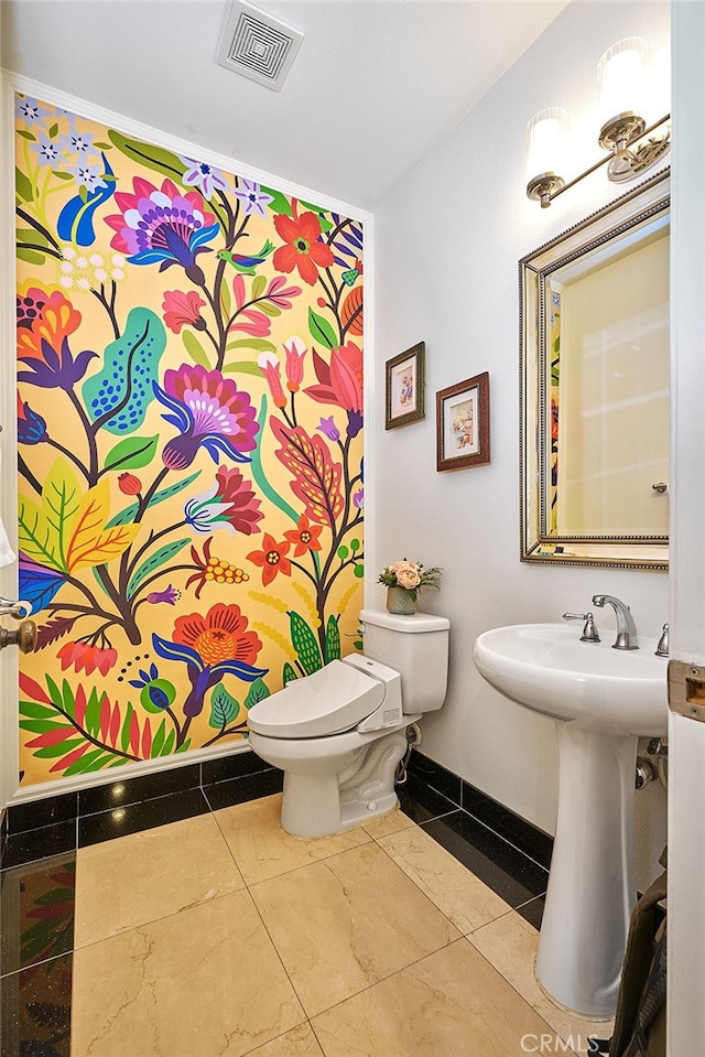 bathroom featuring tile patterned flooring, sink, and toilet