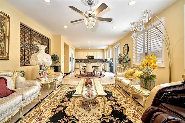 living room featuring ceiling fan with notable chandelier