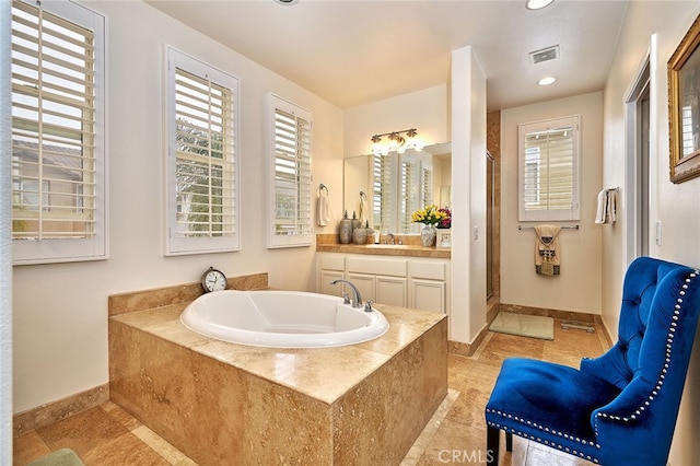 bathroom featuring shower with separate bathtub, tile patterned flooring, and vanity