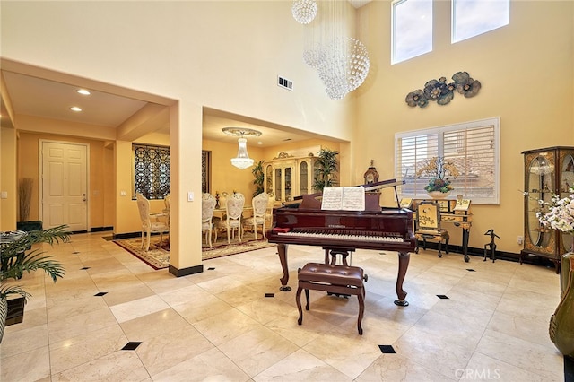 misc room with a high ceiling and a chandelier