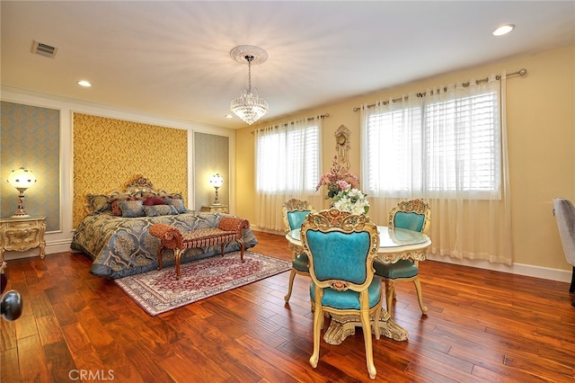 bedroom with a chandelier and hardwood / wood-style flooring