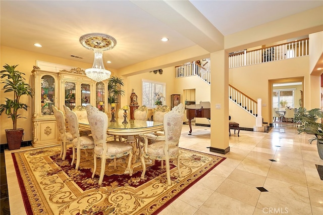 dining area featuring an inviting chandelier, light tile patterned flooring, and a healthy amount of sunlight