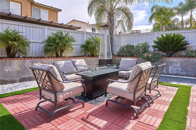 view of patio / terrace with a deck and a fire pit