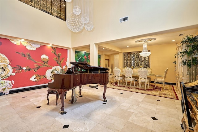 misc room with an inviting chandelier and a high ceiling