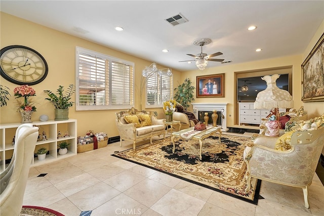 living room featuring light tile patterned floors and ceiling fan