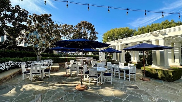 view of patio with outdoor dining space and a pergola